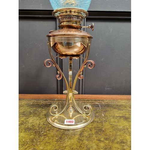 1402 - An Art Nouveau copper and brass oil lamp, in the manner of WAS Benson, with Vaseline glass shade, he... 