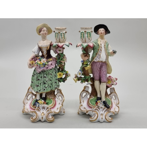 1417 - A pair of Derby porcelain figural candlesticks, 24cm high, (extensive restoration).