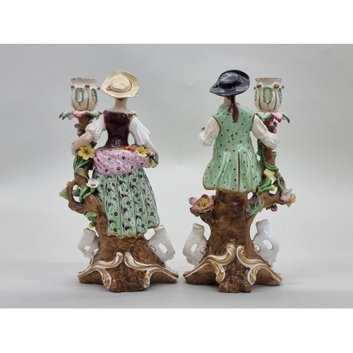 1417 - A pair of Derby porcelain figural candlesticks, 24cm high, (extensive restoration).