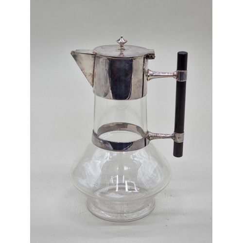 1418 - A late 19th century clear glass and electroplate claret jug, after a design by Christopher Dresser, ... 