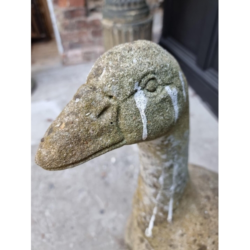 1147 - An old weathered composition stone goose, 63.5cm high, (repaired). 