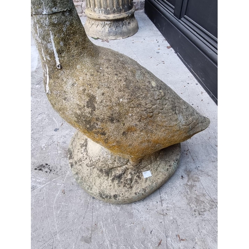 1147 - An old weathered composition stone goose, 63.5cm high, (repaired). 