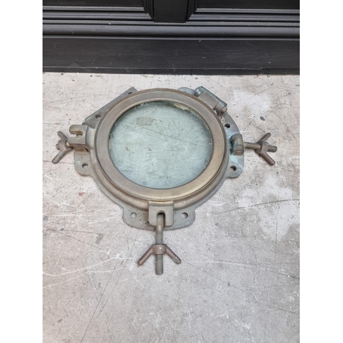 1164 - A large bronze ship's porthole, 58cm diameter, (in salvaged condition).