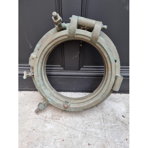 1165 - A bronze ship's porthole, 49cm diameter, (in salvaged condition).