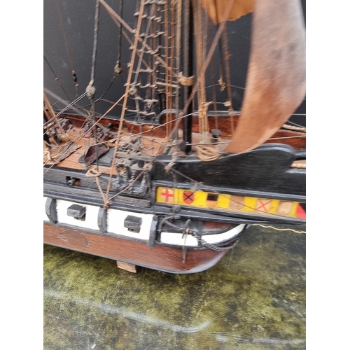 1178 - A painted wood model galleon, 70cm long, on wood stand. 