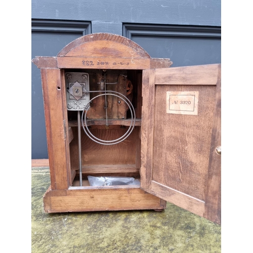 1186 - A circa 1900 oak and inlaid mantel clock, 33.5cm high.