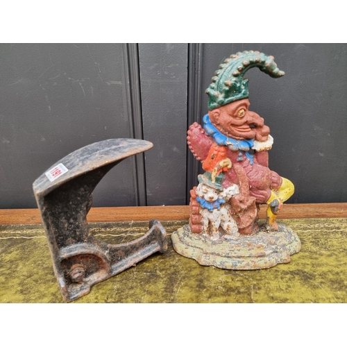 1191 - A polychrome painted cast iron Mr Punch doorstop, 31cm high; together with a cobblers anvil. (2)... 