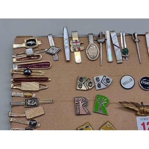 1262 - A collection of tie pins and badges. 