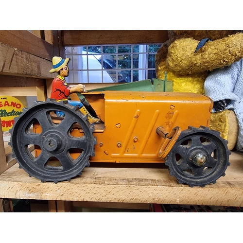 30 - Chiltern Toys: a vintage pull-along plush pixie on trike; together with a Tri-ang Toys tinplate cloc... 