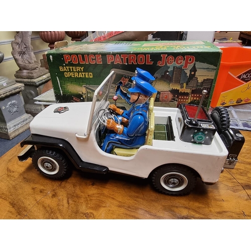 49 - Vintage Toys: a collection, to include: a boxed battery operated Police Patrol Jeep; a clockwork tin... 