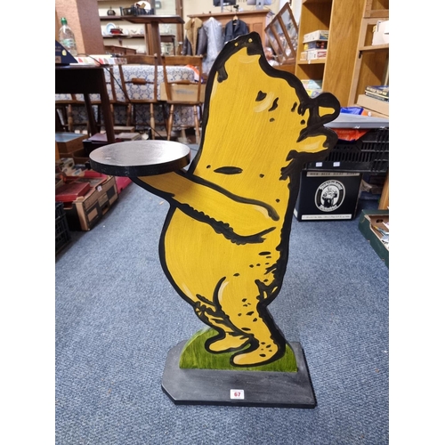 67 - Winnie The Pooh: a painted wood figural dumb waiter, 75cm tall.