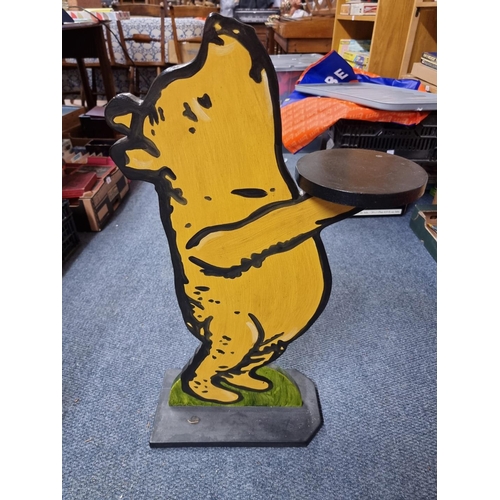 67 - Winnie The Pooh: a painted wood figural dumb waiter, 75cm tall.