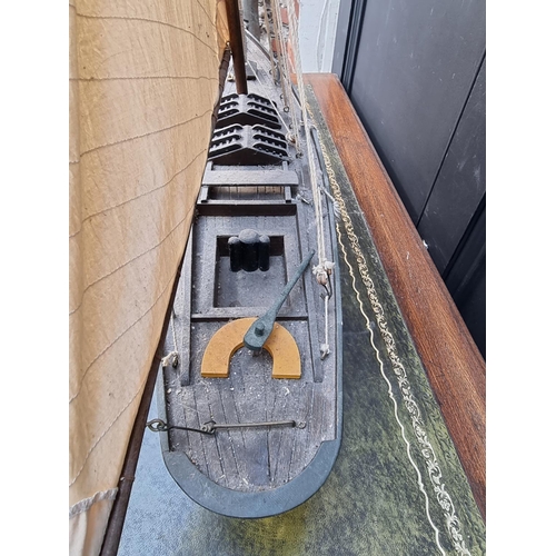 75 - A painted wood pond yacht, total length 83.5cm, on wood stand