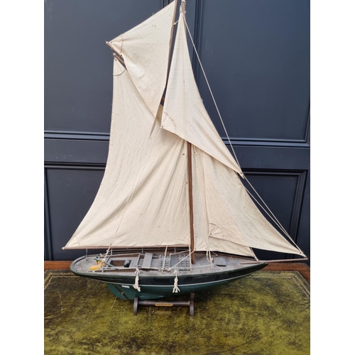 75 - A painted wood pond yacht, total length 83.5cm, on wood stand