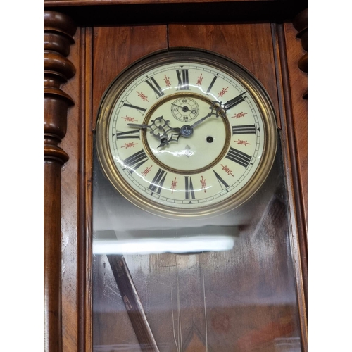 1120 - A late 19th century walnut Vienna style wall clock, by 'Gustave Becker', 120cm high, with pendulum a... 