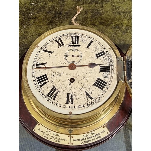 1125 - An interesting ship's brass bulkhead clock, with 6in dial, the stained wood mount bearing ivorine la... 