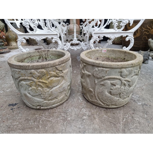 1149 - A pair of composition stone garden planters, with relief decoration, 31.5cm high x 39cm diameter.... 