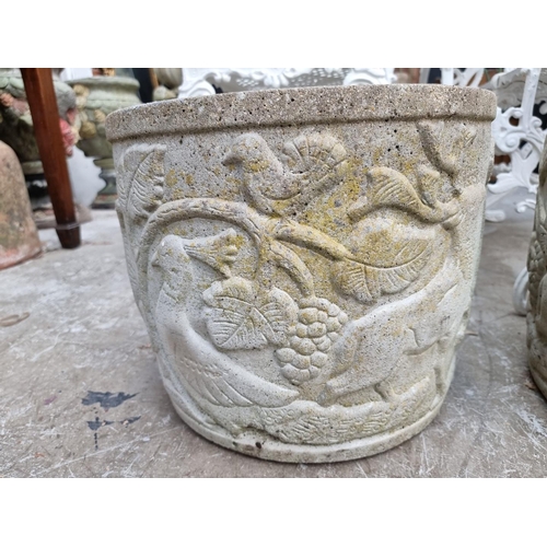 1149 - A pair of composition stone garden planters, with relief decoration, 31.5cm high x 39cm diameter.... 