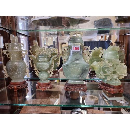 1491 - Three Chinese carved green jade twin handled vases and covers, 22cm high; together with another... 