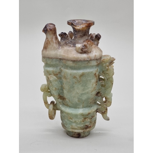 1492 - A Chinese Archaistic style carved green and russet jade ewer and cover, 22cm high, (chips to cover).... 