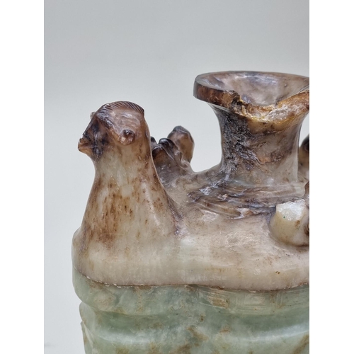 1492 - A Chinese Archaistic style carved green and russet jade ewer and cover, 22cm high, (chips to cover).... 