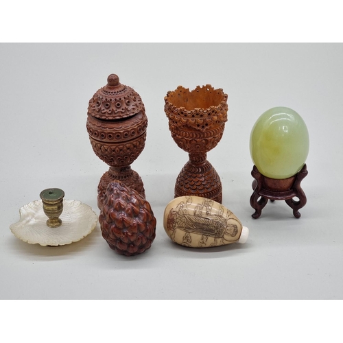 1507 - A mixed group of eastern works of art, to include a carved coquilla nut egg cup; a jade egg; a veget... 