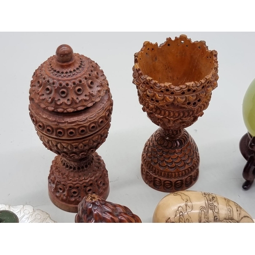 1507 - A mixed group of eastern works of art, to include a carved coquilla nut egg cup; a jade egg; a veget... 