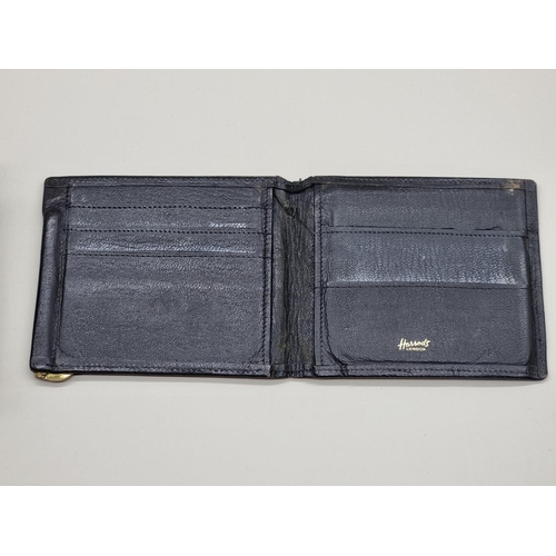 1511 - A 9ct gold mounted snakeskin wallet, by Asprey; together with another Harrods black leather exa... 