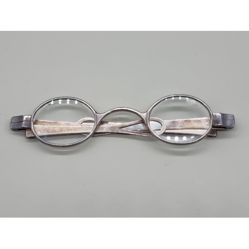 1517 - A pair of George III silver spectacles, London 1802, one arm indistinctly inscribed 'J.A Do...orth'.... 