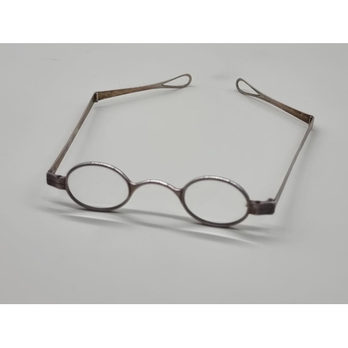 1517 - A pair of George III silver spectacles, London 1802, one arm indistinctly inscribed 'J.A Do...orth'.... 