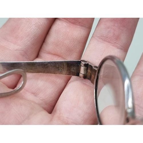 1517 - A pair of George III silver spectacles, London 1802, one arm indistinctly inscribed 'J.A Do...orth'.... 