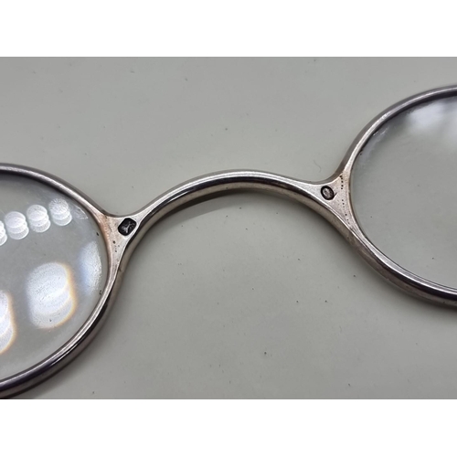 1517 - A pair of George III silver spectacles, London 1802, one arm indistinctly inscribed 'J.A Do...orth'.... 