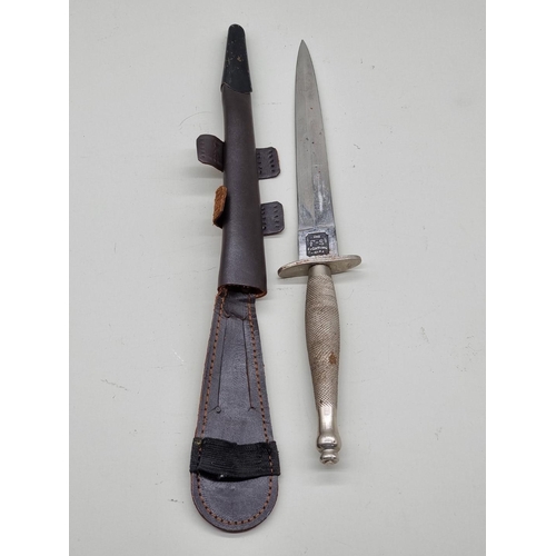 1596 - A Fairbairn Sykes 1st pattern fighting knife and leather sheath, with 15.5cm blade.