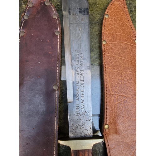 1598 - A Bowie type knife and leather scabbard, the 27cm blade inscribed 'Union Pacific Railway Linked East... 