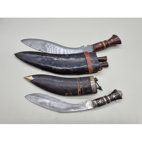 1599 - Two Kukris and leather sheaths. 