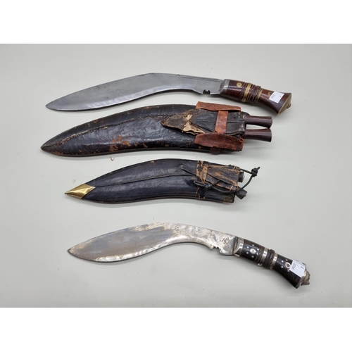 1599 - Two Kukris and leather sheaths. 