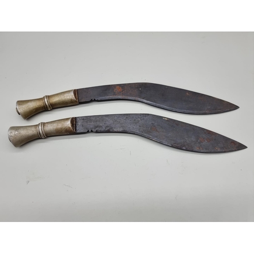 1600 - An unusual pair of metal handled kukris, one handle inscribed 'F G 579', with 34cm and 35cm blades r... 