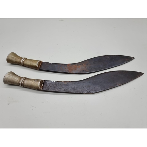 1600 - An unusual pair of metal handled kukris, one handle inscribed 'F G 579', with 34cm and 35cm blades r... 