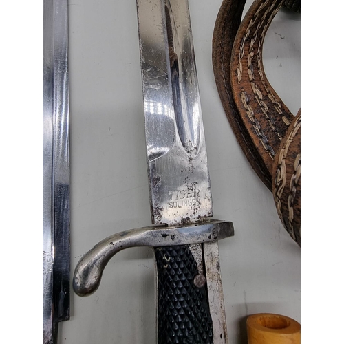 1602 - A German K98 bayonet, by Tiger, Solingen; together with an army dagger blade; dagger grip; two bayon... 