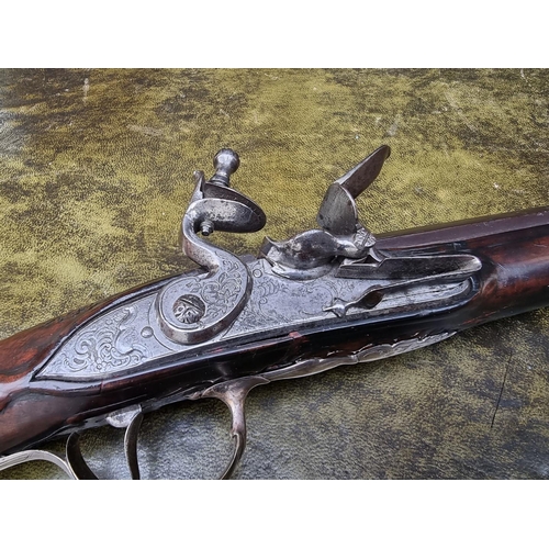 1621 - An 18th century French sporting flintlock musket, with a silver mounted walnut stock and padded chee... 