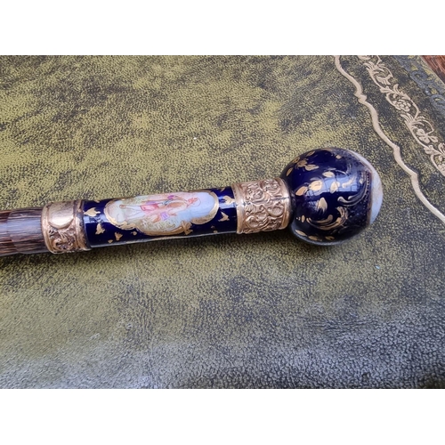 1627 - A porcelain and gilt metal mounted bamboo cane. 