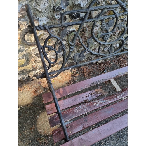 1633 - A cast iron garden bench, with wood slats, 122cm wide.