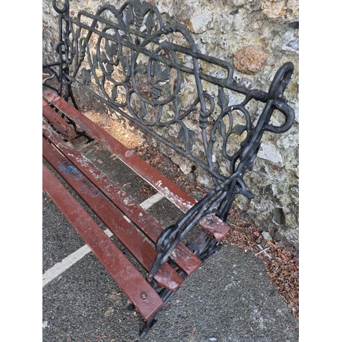 1633 - A cast iron garden bench, with wood slats, 122cm wide.