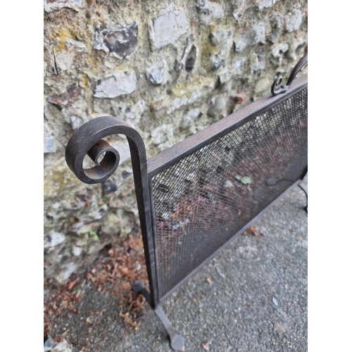 1634 - A black painted steel fire guard, 91.5cm.