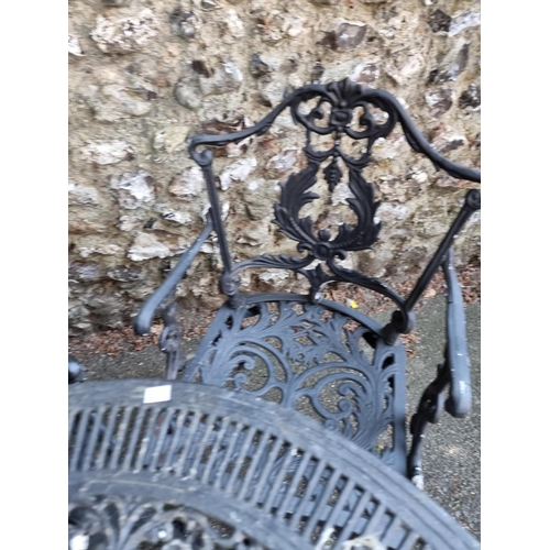 1639 - A black painted aluminium garden table, 80cm diameter; together with four chairs.... 