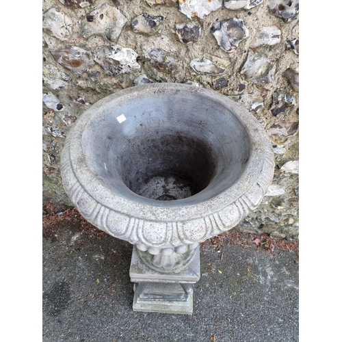 1649 - A composition stone Campana urn and pedestal, 113cm high.