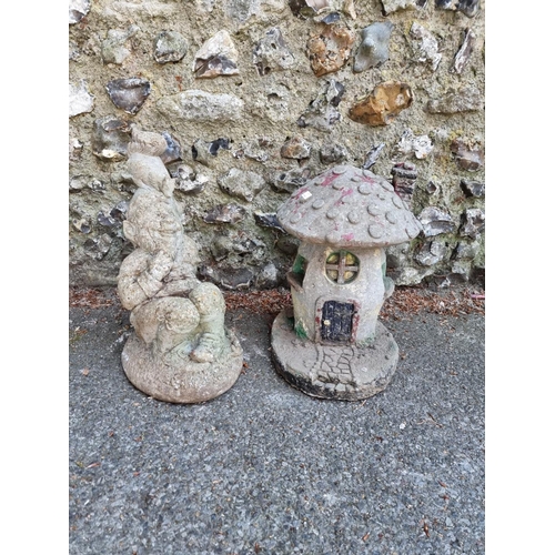 1655 - A reconstituted stone garden gnome; together with a similar toadstool figure.