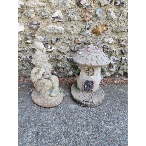 1655 - A reconstituted stone garden gnome; together with a similar toadstool figure.