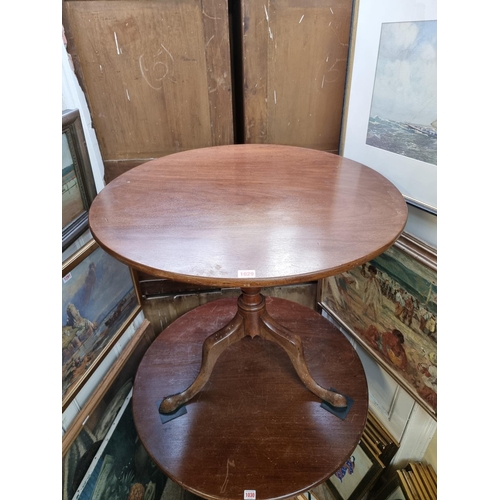 1029 - A George III mahogany circular tilt top tripod table, with one-piece top, 79cm diameter.... 