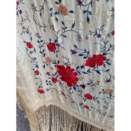 1315 - A Chinese embroidered silk shawl, finely decorated with flowers, size excluding tassels approx 135cm... 